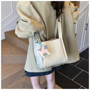 Minimalist bucket bag for women, chic leather single shoulder tote with cute pegasus charm.