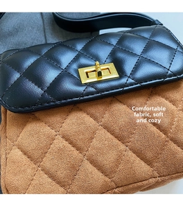 Detail of rhombic quilted stitching with gold twist lock on two-tone crossbody bag