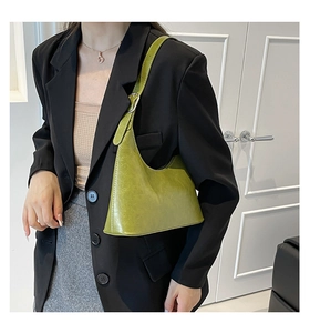 Detail view of the green vintage hobo bag made from polished synthetic leather
