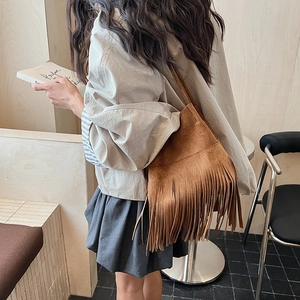 Brown suede shoulder bag with long fringes and minimalist vintage bucket style design