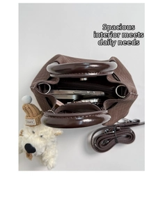 Top view of coffee brown woven bucket bag showing internal capacity for daily essentials