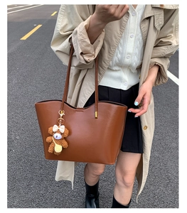 Vue détaillée du grand sac cabas marron foncé en cuir brillant avec bijou d'ours