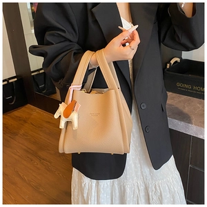 Elegant small bucket bag with cute horse charm, premium leather handbag for daily chic style.
