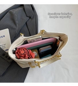 Internal view of large capacity white quilted tote bag with tablet and daily essentials