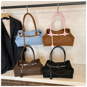 Detail view of large leopard print tote bags in blue, yellow, brown and black colors