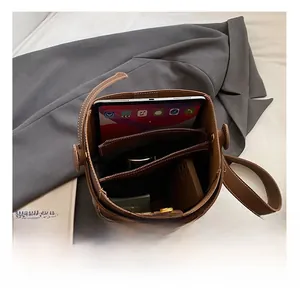 Interior view of brown leather bucket bag showing compartments and spacious storage capacity