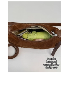 Top view showing large capacity of the brown suede crossbody bag with daily essentials