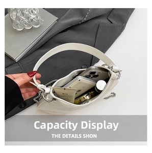 Internal view of a white studded bucket bag showing storage capacity for phone and cosmetics