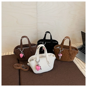 Detail view of mini tote bags in leopard and solid colors with heart charms