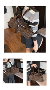 Detail view of large leopard print tote bag featuring brown leather straps and metal buckles