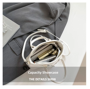Spacious white leather tote bag showing internal storage for phone and cosmetics