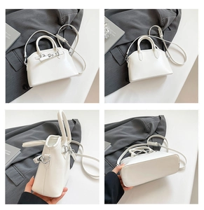 Detail view of white shell bag showing front, back, side and base with metallic buckle