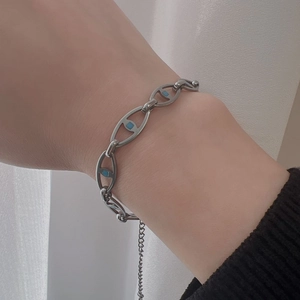 Detailed close-up of hip-hop titanium steel bracelet with blue rectangular stone inlays