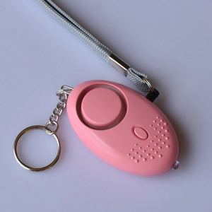 Pink egg-shaped personal security alarm with metal keychain and braided lanyard strap