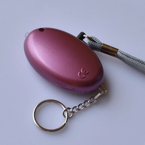 Detail of purple metallic personal alarm with LED light, CE mark, and wrist strap
