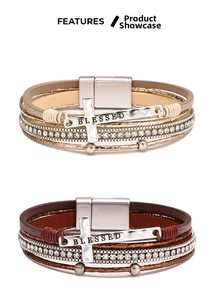 Detail of bohemian wrap bracelets with rhinestone cross and Blessed engraving