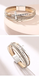 Macro detail of multilayer PU leather bracelet with silver cross and crystal accents