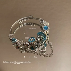 Detail of silver beaded bracelet with sky blue crystals and floral pendants for 13-16cm wrists