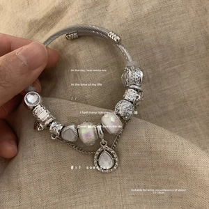 Detail of beaded steel bracelet with love heart charm for wrists 13-16cm
