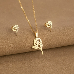 Minimalist gold rose jewelry set featuring a cutout pendant necklace and matching earrings
