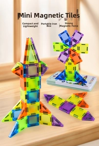 Detail of colorful magnetic building tiles with metal storage box in a home setting