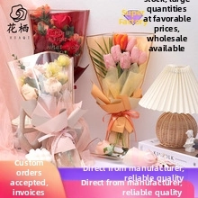 Close-up of floral foam block holding artificial rose and tulip bouquet in warm tones
