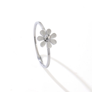 Minimalist silver daisy flower ring with white enamel petals on a stainless steel band