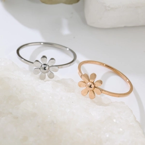 Minimalist daisy flower rings in silver and rose gold finishes on white crystal stone
