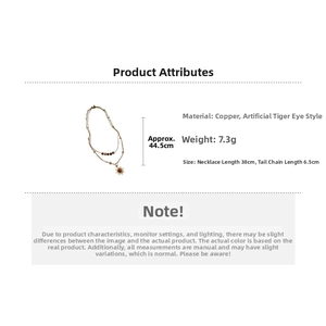 Detail of vintage double-layer necklace with tiger eye beads and sunburst pendant charm