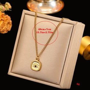 Detail of evil eye pendant with black stone and 18k gold plated stainless steel chain