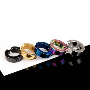 Close-up of five colorful clip-on earrings in black gold blue rainbow and silver finish