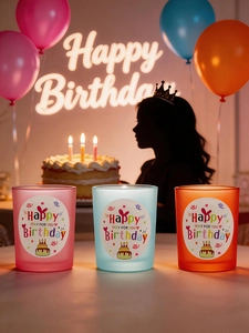 Three-piece frosted glass candle holders in pink, blue, and orange for birthday party