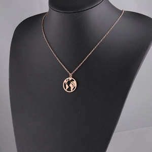 Detailed macro view of the rose gold world map pendant on a sleek metal chain