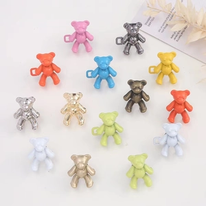 Detail showing various colors of bear-shaped adjustable waist buckles with side hooks
