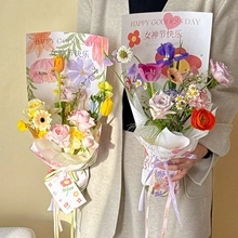 Detail of floral bouquet paper wrapping with Goddess Day prints and colorful flower stems