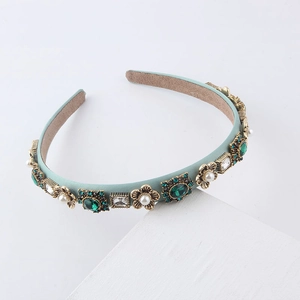 Detail of light blue baroque headband featuring vintage gold metal, green gems and pearls
