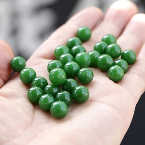 Close-up of green natural jade beads with a smooth oily luster for DIY jewelry making