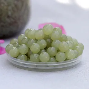Macro detail of natural Hetian Qingshui jade round beads with smooth polished finish