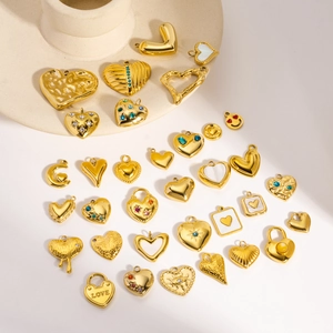 Collection of assorted gold heart-shaped DIY charms and pendants with colorful crystals