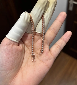 Macro view of rose gold tennis bracelet featuring round brilliant moissanite stones