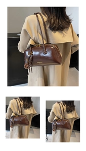 Detailed view of a woman wearing a retro brown leather tote bag with glossy finish