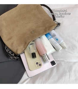 Detail showing the large storage capacity of this suede tote bag for daily essentials