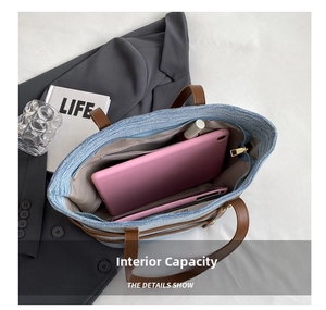 Detailed interior of a blue denim tote bag showing its large capacity for a tablet