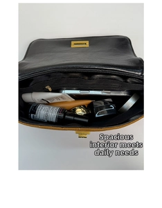 Top view of spacious interior compartment in black leather crossbody bag with zipper pocket