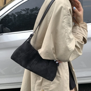 Minimalist black matte leather crossbody hobo bag with sleek vertical stitching details