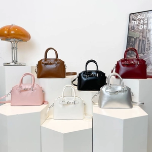 Minimalist shell-shaped crossbody handbags in six colors on geometric stands
