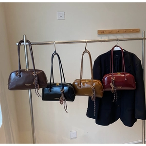 Detail showing vintage bowling bags in four colors with glossy finish and woven charms