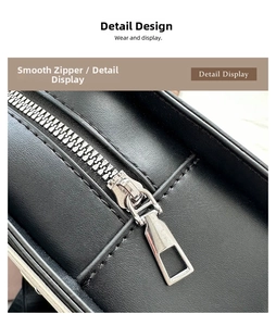 Close-up of a smooth metal zipper and reinforced stitching on a black leather violin bag