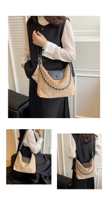 Detail of khaki suede underarm bag with black flap, chain strap and round button accent