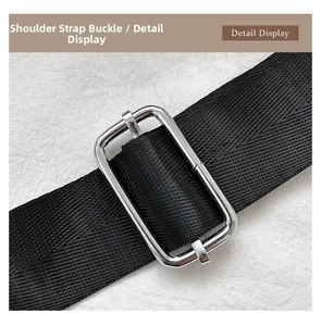 Detail view of adjustable silver metal buckle on durable black nylon shoulder bag strap